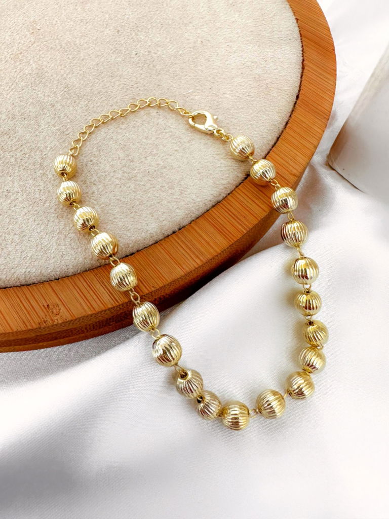 Pulseira folheada a ouro 18k e prata 925 de esferas estonadas.